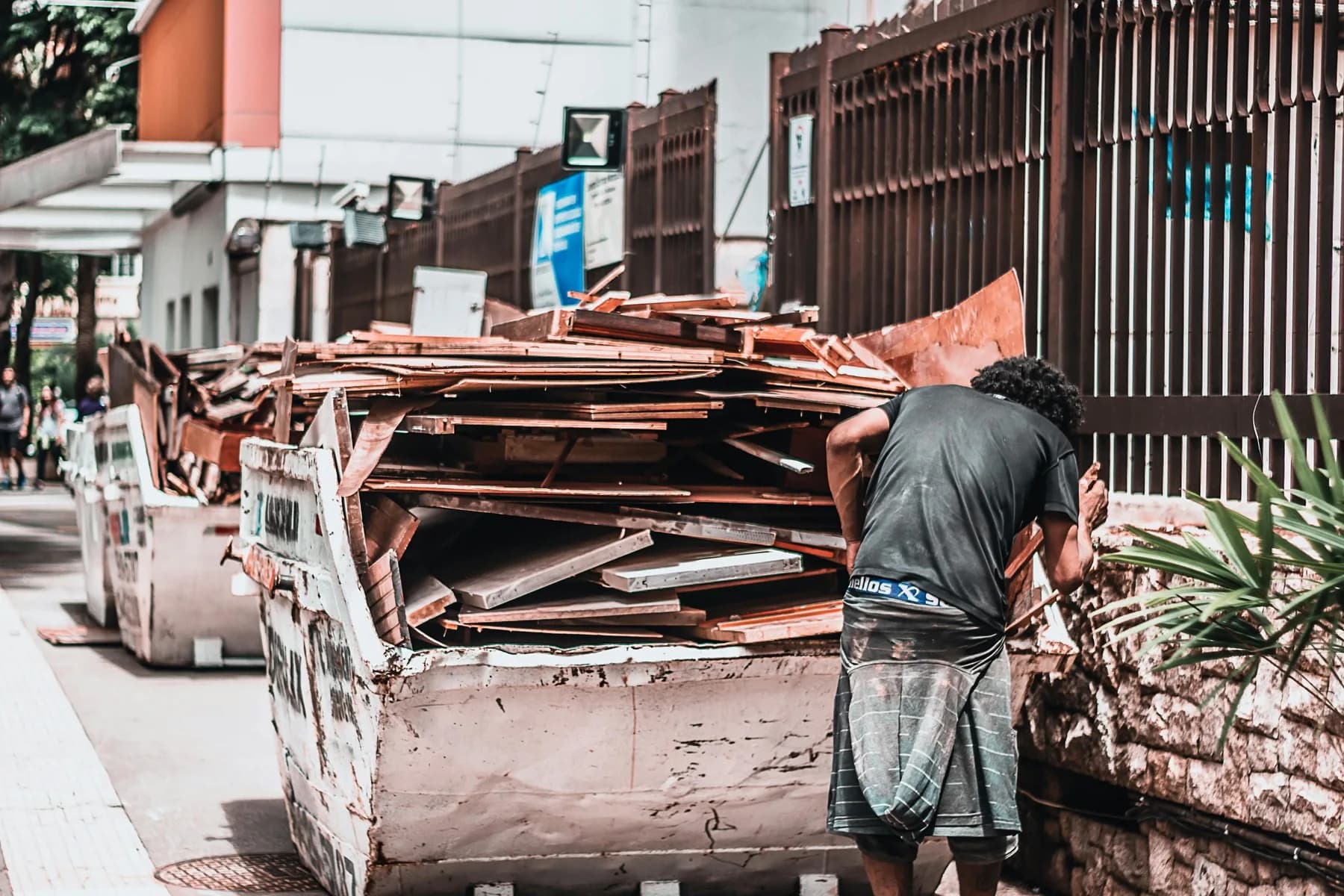 Orange roll-off dumpster loaded with demolition debris — weight-cap visual
