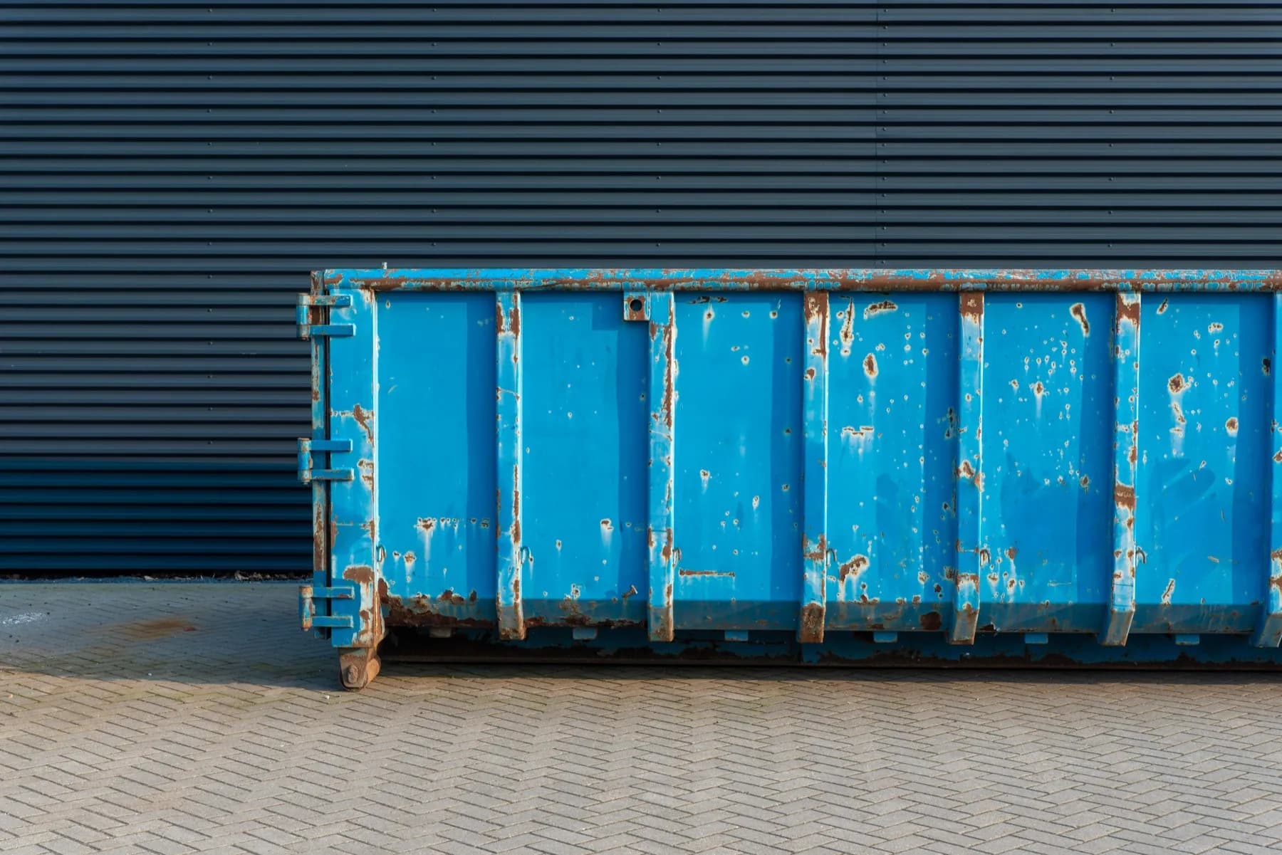 Blue roll-off dumpster on a Canadian residential lot — Wastebins.ca pricing example